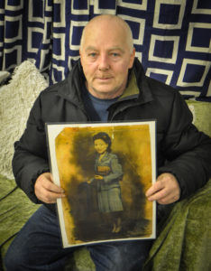 Peter Kelly with a photograph of his mother